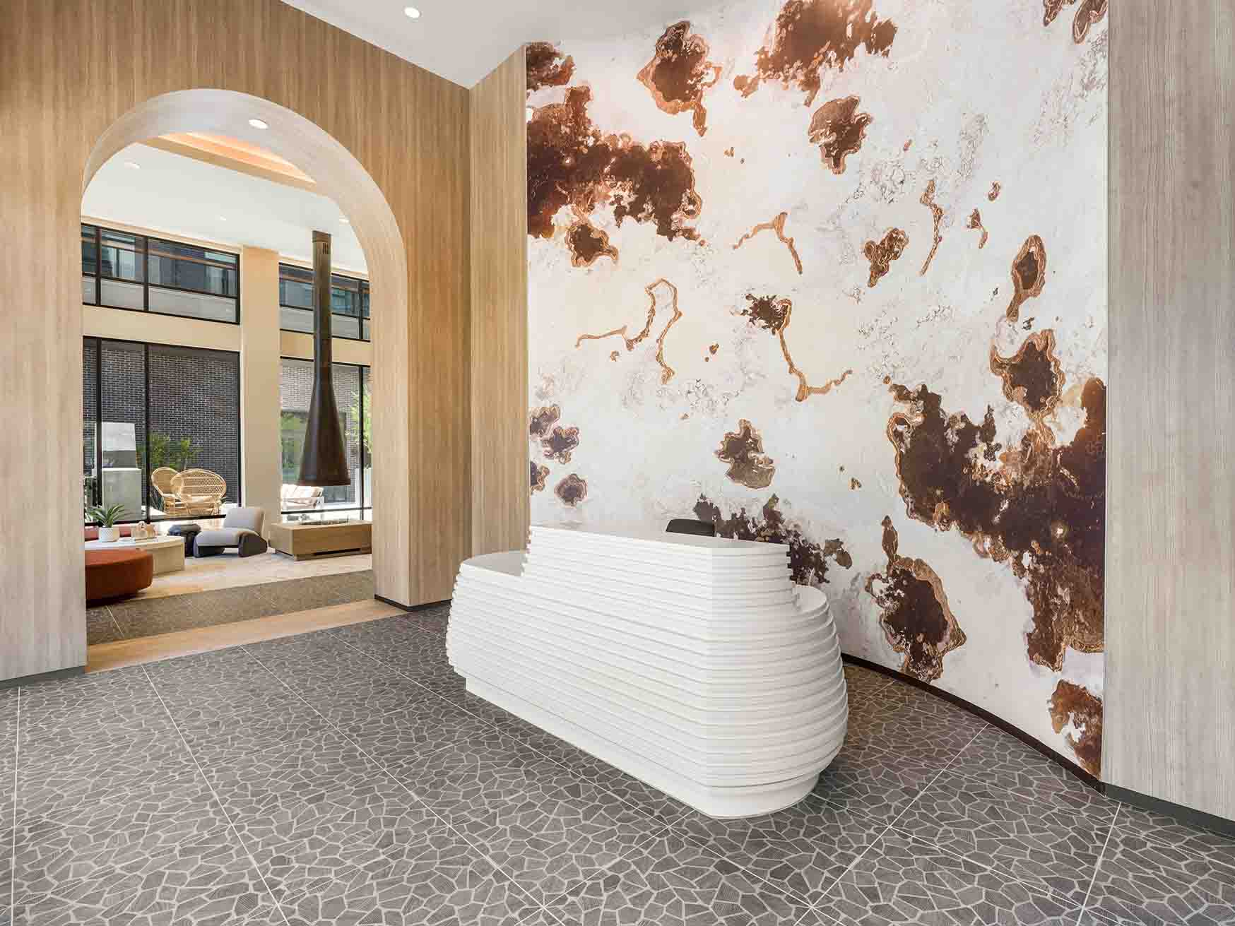 A dynamic view of the reception area shows the 6-by-17-foot Hutchman 31 wallcovering as the centerpiece behind the curved white desk. 
