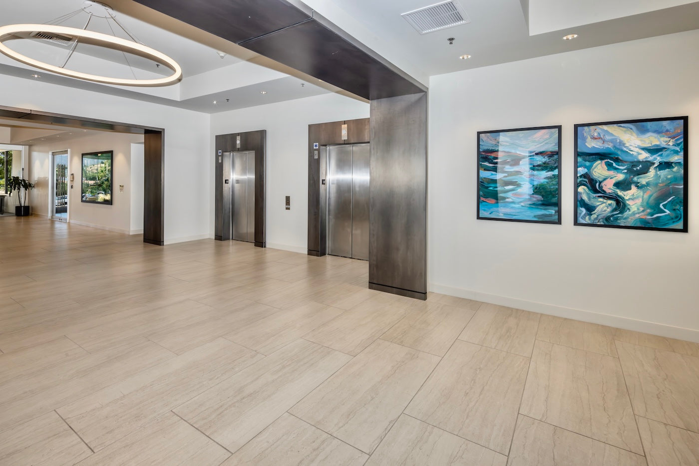 An airy lobby in Westlake Landmark features print reproductions of Depths Reflected and Trembling Waters by ArtLifting artist Elizabeth Shanahan, whose fluid, nature-inspired compositions in blues and greens echo the surrounding California landscape and bring a sense of calm movement to the space.