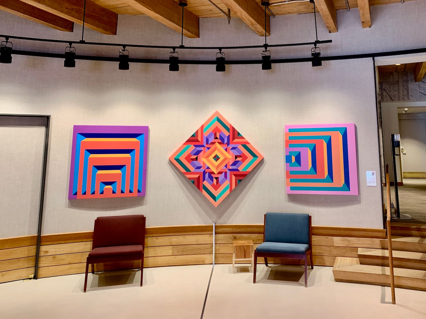 At 313 Congress Street, this vibrant lobby installation features three print reproductions by ArtLifting artist Rick Ruark, whose bold geometric patterns and dynamic color combinations bring energy and dimension to the space, complementing the natural wood accents and architectural warmth of the lobby.