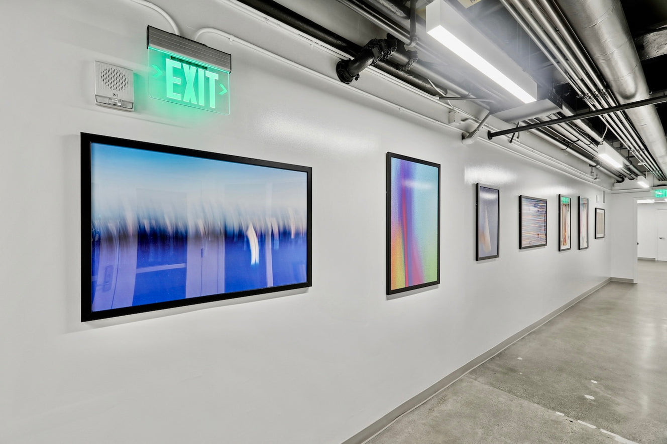 A Fitness Corridor at 475 Sansome features a series of print reproductions by ArtLifting artist Peter Perrino, whose abstract, light-filled compositions use color and motion to create a dynamic sense of energy that enlivens the minimalist, industrial setting.