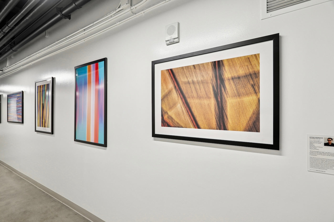 A Fitness Corridor at 475 Sansome features a series of print reproductions by ArtLifting artist Peter Perrino, whose abstract, light-filled compositions use color and motion to create a dynamic sense of energy that enlivens the minimalist, industrial setting.