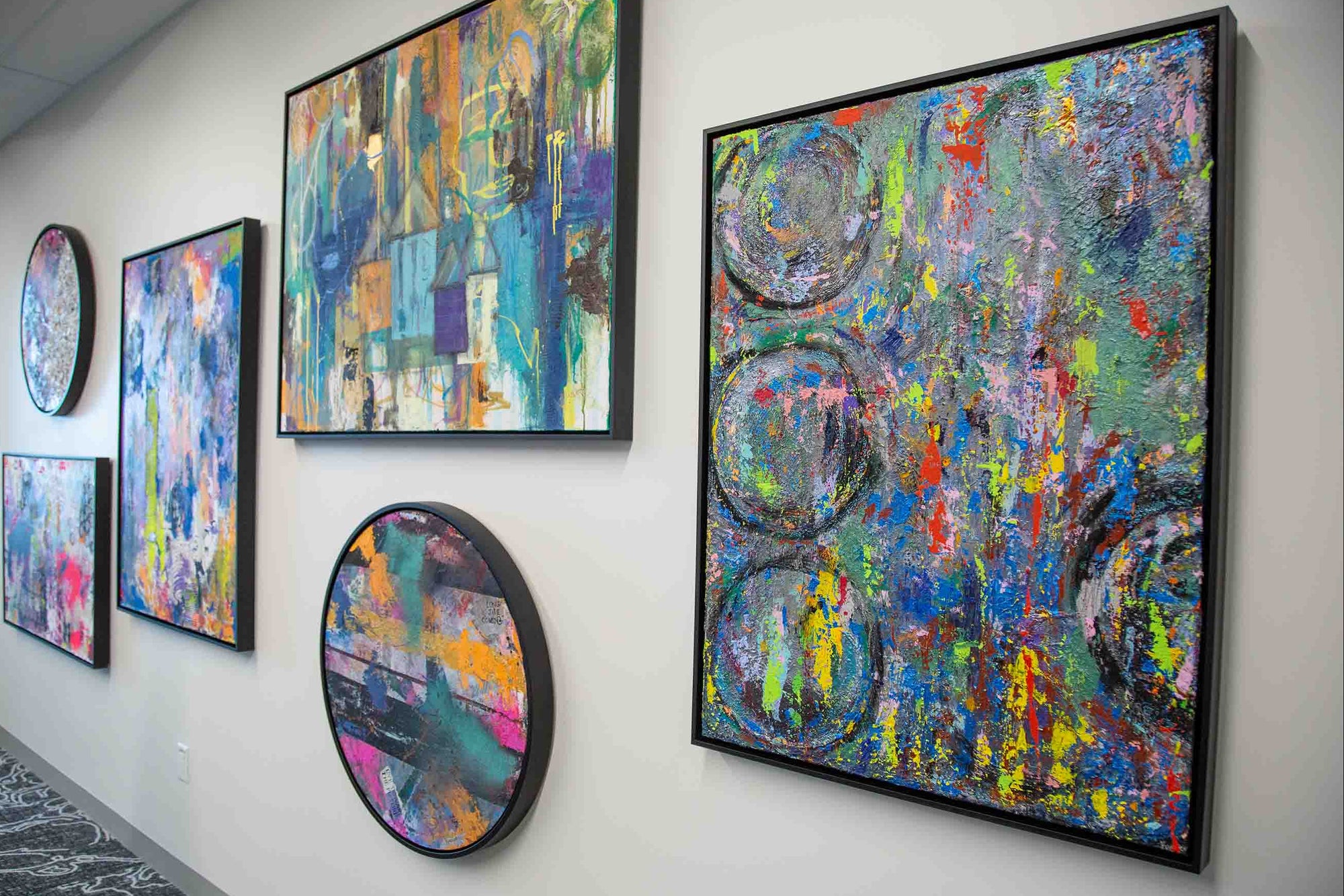 Colorful abstract artwork on a wall in an indoor setting