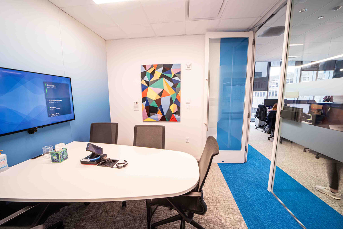 Kennedy Nganga’s piece Cool Colorful Geometrics hangs on the wall of a meeting room. Photography by Michael Madden.