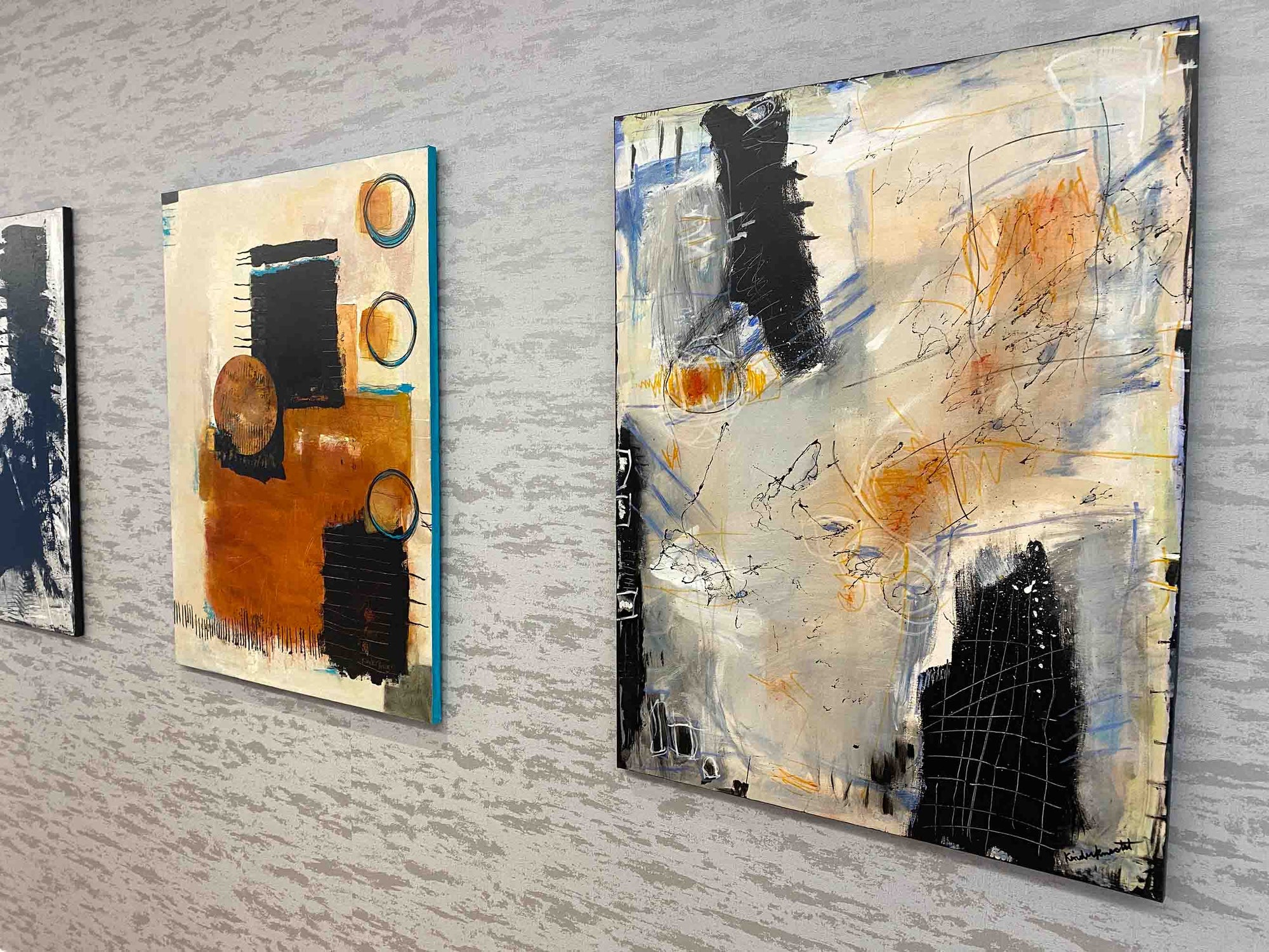 Abstract art pieces on a gray wall