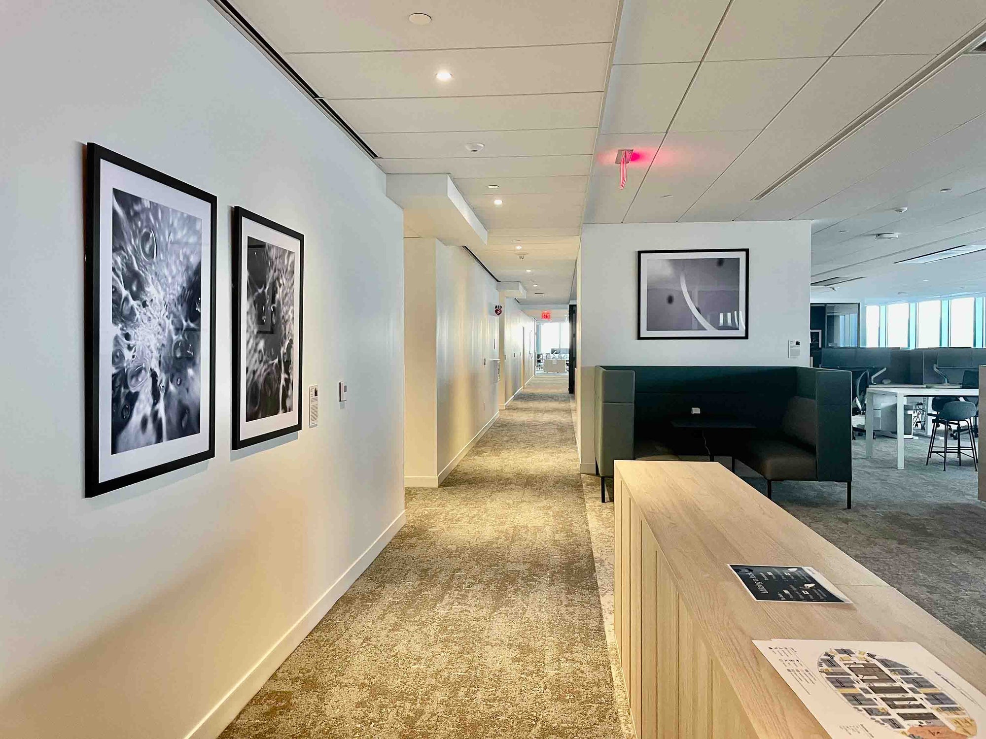 Modern office hallway with framed artwork on the walls