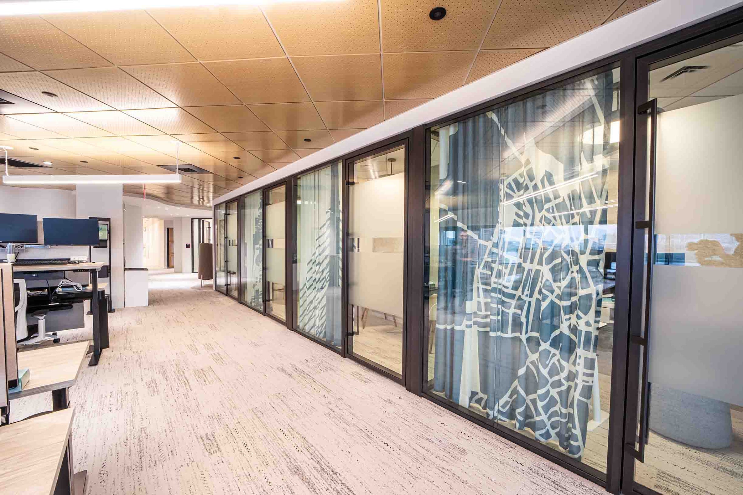 Curtains with Allen Chamberland’s artwork licensed on them covering glass-walled offices. Photography by Michael Madden.