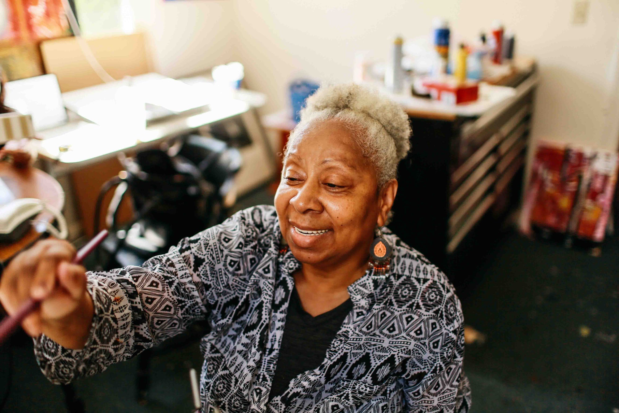 Woman holding a paintbrush in an art studio setting