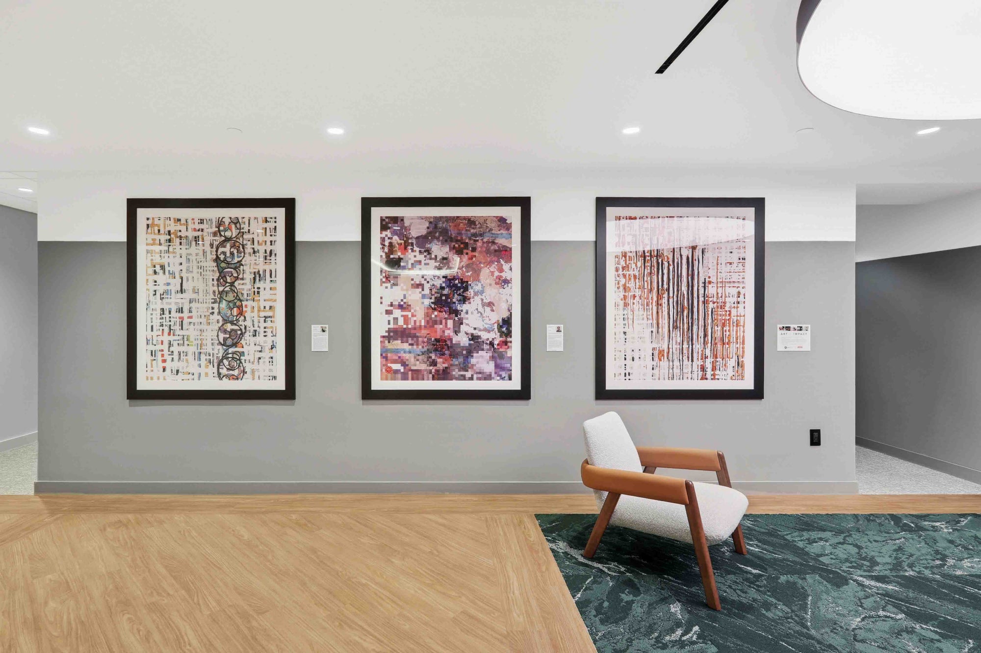 Modern interior with abstract art on the wall and a chair.